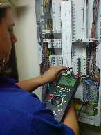 picture of a person testing an electrical installation using a test instrument